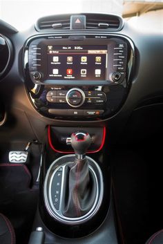 the interior of a car with an electronic device and steering wheel, dashboard controls, and other accessories