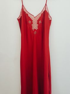 Stunning vintage red slip dress with lace detailing at neck line. Red V-neck Slip Dress For Sleep, Red Bias Cut Slip Dress For Summer, Red Bias Cut Slip Dress For Evening, Sleeveless Party Nightgown With Delicate Lace, Sleeveless Lace Party Nightgown, Sleeveless Lace Nightgown For Party, Red Sleeveless Dress With Lace Trim, Sheer Slip Dress With Spaghetti Straps For Night, Elegant Red Camisole Slip Dress