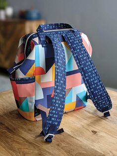 a multicolored bag sitting on top of a wooden table