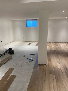 an empty room with wood floors and unfinished walls