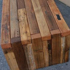 a bench made out of wooden planks on the ground