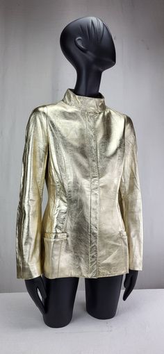 Thierry Mugler Gold Leather Jacket -Measurements: *Shoulder to Shoulder < 34cm *Bust/Back < 44cm *Waist < 37cm *Hips < 52cm *Sleeves < 62cm *Underarm < 42cm *Length < 67cm Condition is very good with only minor colour fading on sleeve, although not really noticeable Sleek Fitted Leather Jacket For Evening, Designer Fitted Leather Jacket For Evening, Fitted Luxury Leather Jacket For Evening, Designer Fitted Leather Jacket For Office, Luxury Fitted Leather Jacket For Party, Luxury Structured Outerwear For Party, Chic Metallic Outerwear For Formal Occasions, Structured Outerwear For Fall Party, Metallic Fitted Outerwear For Formal Occasions