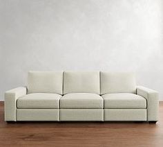 a white couch sitting on top of a wooden floor