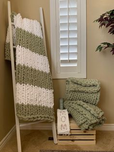 a towel rack with two green and white towels on it