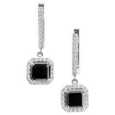 Square black diamond and round white diamond dangle earrings. 2 center square black diamonds with white diamond halos and diamond clip post tops. Designed in the Peter Suchy Workshop. 2 square black diamonds, Included approx. 2.97cts 60 round brilliant cut diamonds G-H VS, approx. .32ct 18k White Gold Tested: 18k 4.7 grams Top to Bottom: 23.7 to 15/16 Inch Width: 8.4mm or 1/3 Inch Depth or thickness: 5mm White Diamond Dangle Earrings, Antique Wedding Bands, Diamond Sapphire Engagement Ring, White Diamond Earrings, Antique Engagement Rings Vintage, Black Diamond Earrings, Antique Bracelets, Vintage Sapphire, Diamond Engagement Rings Vintage