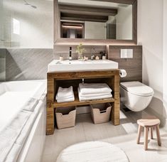 a bathroom with a sink, toilet and bathtub in it's own area