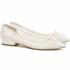 a pair of white shoes with lace on them