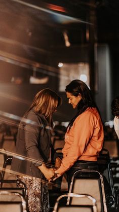 two women sitting in chairs talking to each other