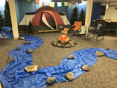 a tent is set up in the middle of a room with blue tarp covering it