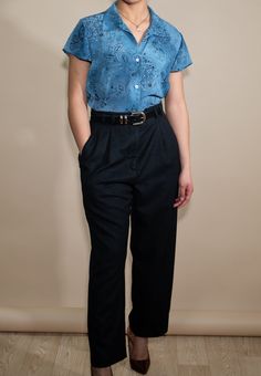 This elegant blue blouse is such a classic staple, features buttons all the way down the front, a classic collar style in a gorgeous floral & paisley, a true statement piece. It can be perfectly paired with trousers or a black mini skirt and knee high boots. Fabric: 100 Polyester x Marked Sz Medium Unisex Blue Floral Top: Best fits XS - Medium depending on desired fit. This item is pinned. Model is a S, 5 ft 4 in (162.5 cm) x 34/26/36 x US 2/4. Flat Approximate Measurements:  Marked Size Medium Length 24 in.  Pit To Pit 20 in.  Arm Length 5 in.  Shoulder to Shoulder 16.5 in. Ships worldwide in biodegradable & recyclable packaging. Ask about free shipping. Unless noted, vintage items have been pre-loved, are subject to imperfections & some subtle stains. We do our absolute best to ensure ea Elegant Floral Print Blouse With Relaxed Fit, Blue Fitted Blouse For Semi-formal Occasions, Classic Formal Tops With Floral Print, Formal Blue Floral Print Tops, Classic Floral Print Blouse For Work, Elegant Blue Relaxed Fit Blouse, Tailored Blouse For Semi-formal Spring Occasions, Blue Semi-formal Blouse With Button Closure, Semi-formal Blue Blouse With Button Closure