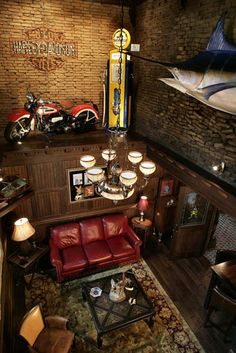 a living room filled with furniture and a fish statue hanging from the ceiling above it