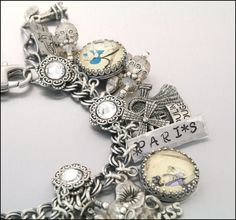 A Paris charm bracelet! Antique Bracelets With Vintage Charm As Gift, Antique Souvenir Jewelry With Charms, Personalized Bracelet Jewelry As Souvenir, Personalized Bracelet Jewelry Souvenir, Personalized Bracelet Jewelry For Souvenir, Antique Adjustable Charm Bracelet Gift, Personalized Vintage Antique Silver Jewelry, Silver Symbolic Jewelry Souvenir, Vintage Adjustable Engraved Charm Bracelet