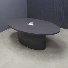 a round table with a square white plate on it's center surface in a room