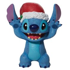 Enesco's Studio Brands is the one-stop-source for quality gifts and collectibles licensed from the world’s most innovative and desired entertainment brands while being recognize for value, craftsmanship and authenticity. Everyone's favorite alien, Stitch, smiles jollily in his Santa hat this Christmas. With a bushel of holly tucked in his cap, he's ready for merry mischief. Hula through the holiday with Lilo's most festive friend and spread love to your Ohana.•DEPARTMENT 56 FIGURINE: from the Di Christmas Stitch, Lilo Y Stitch, Lilo Et Stitch, Disney Traditions, Mini Figurine, Disney Holiday, Cast Stone, Lilo Stitch, Disney Lilo