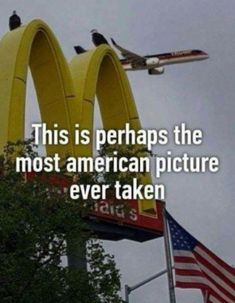 an airplane flying over the top of a mcdonald's sign