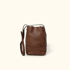 Madison Leather Bucket Bag | Dark Hazelnut Luxury Brown Bucket Shaped Bag, Leather Bucket Satchel For On-the-go, Brown Bucket Bag For On-the-go, Classic Brown Bucket Bag For On-the-go, Cognac Bucket Bag For On-the-go, Leather Crossbody Bucket Bag For On-the-go, Brown Soft Leather Bucket Bag For On-the-go, Everyday Cognac Bucket Bag With Detachable Strap, Leather Bucket Bag With Leather Lining For On-the-go