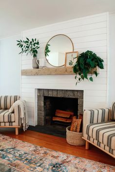 a living room filled with furniture and a fire place next to a wall mounted mirror