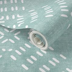 a green and white wallpaper with small dots on the fabric, it is very soft