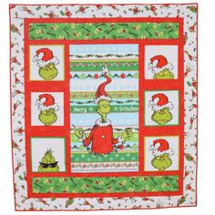 the grin's christmas quilt is shown with santa hats on it and green, red and