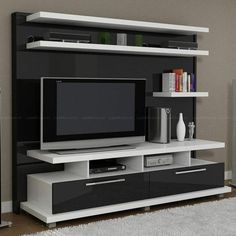 an entertainment center with a flat screen tv on it's stand and shelves below