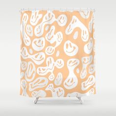 an orange and white shower curtain with abstract shapes on the outside, in front of a gray background