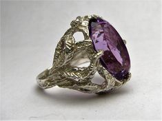 "Handmade Sterling Silver Amethyst Faceted Stone Gemstone Ring 18x13mm (3/4x1/2 inch) 12.5ct Sizing and shipping is ALWAYS FREE with a 14 day \"No Questions Asked\" return policy. *In the notes section of your order, please specify ring size.* This ring is made with real gems. I made it myself, so if you see a setting you like and want a different gem in it, I can put in another one as they are not finished. I can probably do it for the same price or real close. I can make these either in gold o Feb Birthstone, Faceted Gems, Wire Wrapped Rings, I Made It, Handmade Sterling Silver, Gemstone Ring, Matching Earrings, Ring Gift, Jewelry Pieces