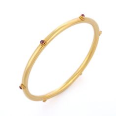 This is part of Chairish’s Fine Jewelry assortment.  Ruby Bangle in 18K Gold. It’s a great jewelry ornament to wear on occasions and at the same time works as a wonderful gift for your loved ones. These lovely statement pieces are perfect generation jewelry to pass on. Bangles feel comfortable while wearing it as it is lightweight, designer and skin friendly. Our handmade solid gold bangles are a stylish accessory which is perfect for your daily casual wear or work formal wear. This is a perfect Heirloom Gold Gemstone Bracelets, Heirloom Gemstone Bangle Bracelets, Heirloom Gemstone Bangle Bracelet, Luxury 22k Gold Bracelets, Fine Jewelry Yellow Gold Bangle With Bezel Setting, Yellow Gold Round Temple Jewelry Bangle, Yellow Gold Bangle With Bezel Setting Fine Jewelry, 14k Gold Bangle Bracelet With Gemstones, Classic Yellow Gold Bangle With Gemstone