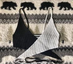 two bras laying on top of a bed next to an elephant blanket and pillow