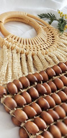 a close up of a woven bag with wood beads