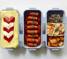 three bento boxes filled with different types of food in each one, including pasta and heart shaped pretzels