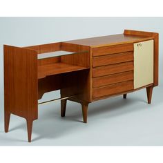 a wooden desk with a glass top and drawers