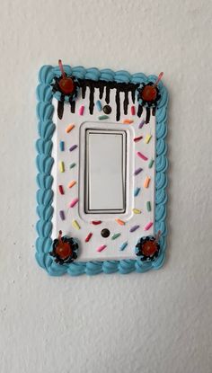 a decorated light switch plate with sprinkles on it