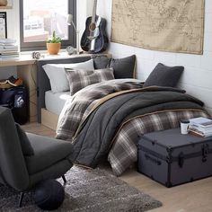 a bedroom with a bed, chair and guitar on the wall next to a window