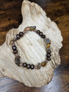 This bracelet is made with chipped tiger's eye gemstones and wooden beads to create a very earthy and natural jewelry piece! .  Tiger's eye symbolizes strength, confidence, bravery, and good fortune. Tiger Eye Bracelet, Tigers Eye Gemstone, Healing Jewelry, Nature Jewelry, Tiger Eye, Gemstone Bracelet, Wooden Beads, Handmade Bracelets, Jewelry Pieces