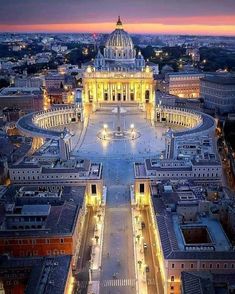 the dome of st peter's cathedral lit up at night in rome, italy