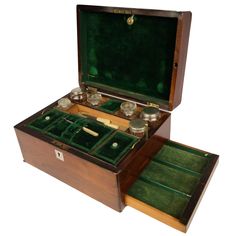 an open wooden box with three different items in it