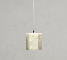 a marble light fixture hanging from a white ceiling with a long cord attached to it