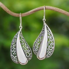 This stunning pair of sterling silver dangle earrings is from the creative mind of artisan Rattiya Chaiwong. The Thai artisan creates each earring in a beautiful leaf shape, with gorgeous openwork bordering a sleek silver center. Rattiya is inspired by the wonderful creations of the hill tribe people in her elegant design. White Teardrop Earrings With Intricate Design, Traditional Handmade Sterling Silver Teardrop Earrings, Artisan Sterling Silver Teardrop Dangle Earrings, Artisan Silver Drop Earrings, Silver Drop Artisan Earrings, Artisan Silver Teardrop Earrings, White Intricate Design Danglers As Gift, White Intricate Danglers For Gift, Artisan Drop Earrings