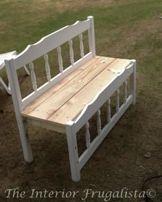 a white bench sitting on top of a grass covered field