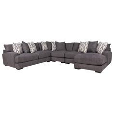 a gray sectional couch with pillows on the top and bottom corner, in front of a white background