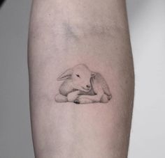 a small rabbit tattoo on the arm