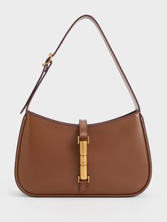 This product is made with at least 20% sustainable materials by weight. CHARLES & KEITH uses recycled, degradable, organic, and water-based materials in our eco-conscious collection.The Cesia minimalist design enhances its versatility, making it the perfect style companion for office hours, casual weekends, and everything in between. With its timeless combination of chocolate brown and metallic gold, it will add a touch of elegance to your everyday wardrobe, effortlessly elevating any look. The Modern Rectangular Recyclable Bag, Everyday Brown Recyclable Bag, Everyday Brown Recyclable Bags, Brown Recyclable Bags For Daily Use, Everyday Rectangular Shoulder Bag With Bamboo Handle, Modern Shoulder Bag With Bamboo Handle For Daily Use, Everyday Bucket Shoulder Bag With Bamboo Handle, Modern Rectangular Bag With Bamboo Handle, Modern Bags With Bamboo Handle For Everyday Use