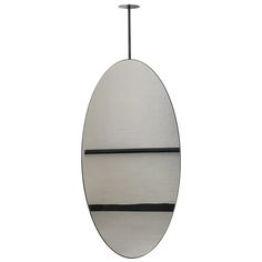 a white surfboard hanging from a metal hook on a white wall with black stripes