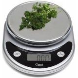 an electronic scale with some green vegetables on it