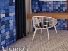 a white chair sitting next to a wooden table in a room with blue tiles on the walls