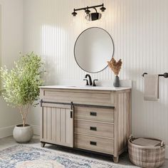 a bathroom with a sink, mirror and rug