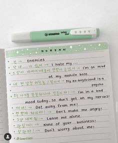 a notepad with writing on it next to a pen