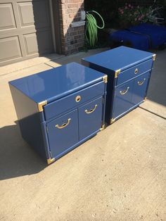 two blue chests sitting in front of a garage