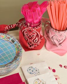 the table is set with pink and red items