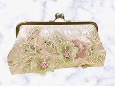 Check out this GORGEOUS clutch from our seller JPE Finery!__ While this purse would be perfect for any special occasion, we think it would especially suit a bride with a blush wedding gown or her maid of honor!__ This handmade clutch was crafted in the state of Washington. __ #handmadeclutch #pinkclutch #floralclutch #handmadefloralclutch #MyCommunityMade #handmadegifts #shopsmallbusiness #etsyalternative #maidofhonorgifts #maidofhonorgift #maidofhonorpurse #weddingpurse #weddingclutch Feminine Beige Evening Bag For Formal Occasions, Designer Beige Clutch Evening Bag, Luxury Handheld Beige Clutch, Luxury Beige Handheld Clutch, Beige Rectangular Formal Clutch, Chic Handheld Clutch As Gift, Handmade Chic Clutch Evening Bag, Beige Clutch With Removable Pouch For Party, Chic Handmade Clutch Evening Bag